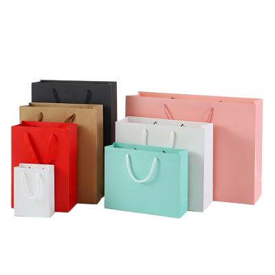 China Recycled Materials Custom Printed Black Carry Treat Shopping Kraft Paper Bag With Rope Handles for sale