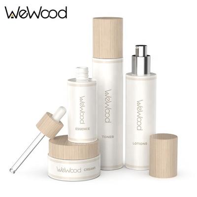 China Fashionalbe Empty Frosted Refillable Skin Care Set Glass Cosmetic Bottles Cosmetic Packaging With Wooden Lid for sale