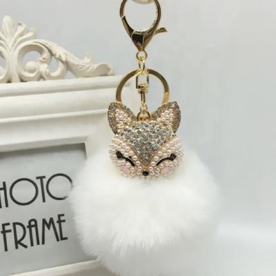 China Plush Faux Fur Ball Pom Pom Keychain With Fox Head Inlay Pearl Artificial Faux Stone For Women Bag Cell Phone Car Pendant White for sale