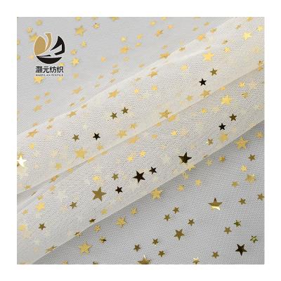 China Other Ready Goods Printing Bronzing Star Patterned Bird Eye Mesh Soft Tulle Fabric For Wedding Dress for sale