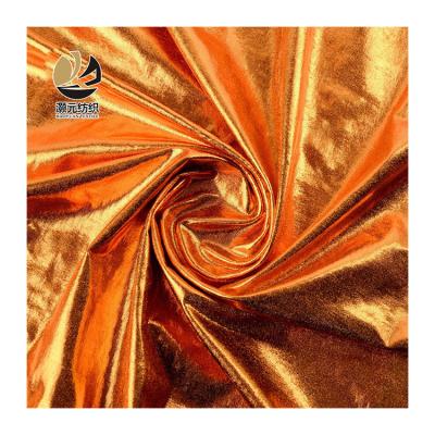 China Other Custom Design Fashion Knitting Shiny Polyester Gold Foil Print Bronzing Dress Fabric For Garment for sale