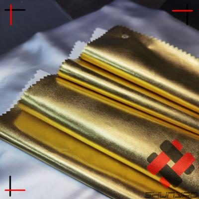 China Factory Wholesale Hot Selling Anti-static Polyester Shiny Gold Foil Metallic Fabric For Garment for sale