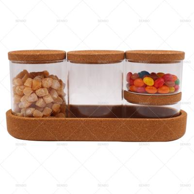 China Food Storage Freshness Preservation 4 Piece Set Decorative Kitchen High Borosilicate Glass Jar Set with Cork Lid and Cork Wooden Base for Spice Food Storage for sale