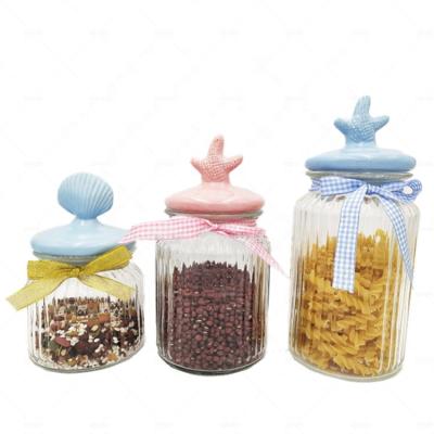 China Freshness Preservation Ribbed Glass Kitchen Canister Snacks Storage Jar With Starfish Ceramic Sea Shell Lid for sale