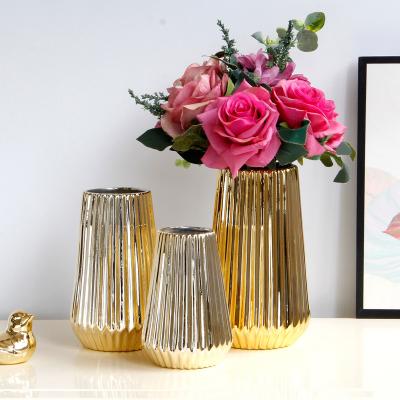 China Novelty Art Golden Ceramic Flower Modern Creative Vase for Weddings Centerpiece Luxury Hotel Office Decoration for sale