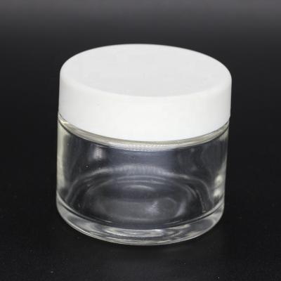 China CBD oil packing 1 ounce 30ml clear weed glass jar straight sided with silver metal lid for powder cbd flower for sale