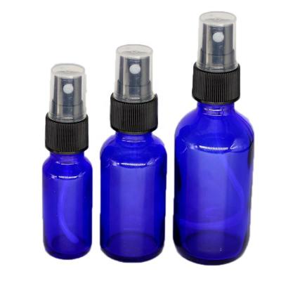 China Personal Care Cobalt Blue Boston Round Glass Bottle / Black Spray Fine Ribbed Mist Sprayer 60ml for sale