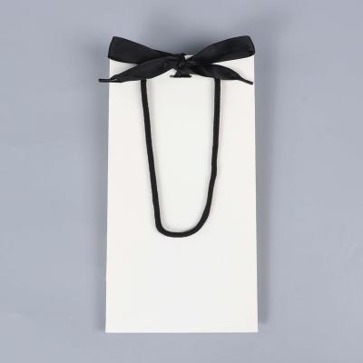 China Recyclable Sturdy Durable Thick White gift bag with Black handle and Ribbon Elegance Gift paper Bag with Satin Bows Ribbon for sale