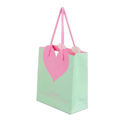 China Recycled Materials Hot Stamping Custom logo Shopping Boutique Paperbag Mini Clothes Christmas Party Pink Gift Paper Bag for sale