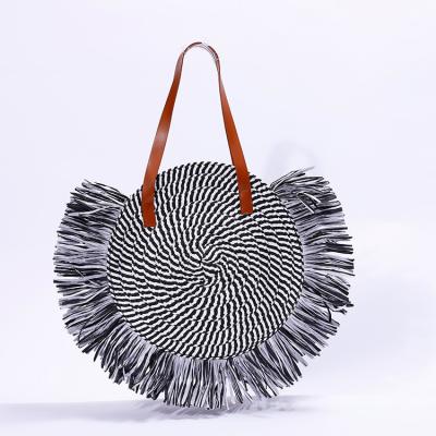 China Lady Wholesale Fashion Cute Black Tassel Zebra Grain Weaving Straw Bags Round Beach Bag For Women for sale