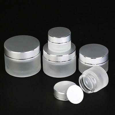 China Skin care 10ml cream 15g 30ml 50ml frosted hot sale glass cosmetic cream jar container with silver cap for sale