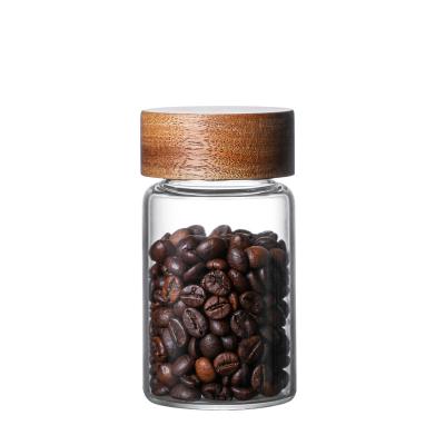 China Minimalist Q Food Grade 10cm Diameter Storage Jar Glass Bottle Square Sealed Coffee Bean Storage Jar With Wooden Lid for sale