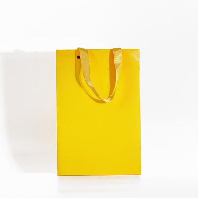 China Recycled Materials Biodegradable Customize Yellow Color Paper Bag For Grocery Sos Paper Bag for sale