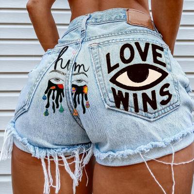 China New Style XW023 2022 Women Breathable Sexy Denim Ripped Shorts Hot Cartoon Printed Pocket Jeans Raw Edge Irregular Pants High Waisted for sale