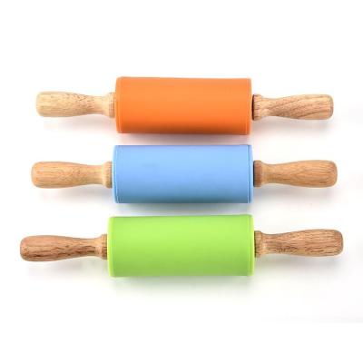 China Mini Size Non-Stick Silicone Rolling Pin with Wooden Handle for Baking Tools for sale