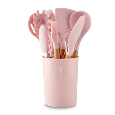 China Viable New Arrival Popular Color Pink Color 12pcs Wooden Handle Silicone Cookware Set With Plastic Holder for sale