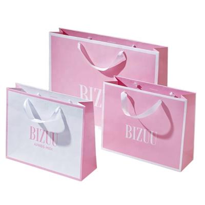 China Recycled Materials Custom Logo Printing Hot Pink Luxury Fashion Shopping Paper Bag With Ribbon Handle for sale