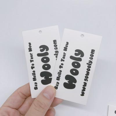 China Custom viable any size any design paper hanger tag fabric tags high quality paper card for hanging tags for sale