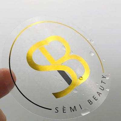 China Anti-counterfeit Custom Gold Foil Self Adhesive Private Label Stickers Printing Logo Printing Transparent Labels Clear for sale