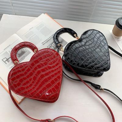 China 2021 autumn fashion love heart bag novelty PU leather handbag the new clip the pattern stone retro cross - body handbags ladies luxury handbags for women for sale