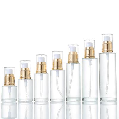 China Personal care 100ml 200ml glass empty clear lotion bottle with pump sparyer glass bottle for cosmetic packaging for sale