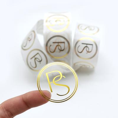 China Logo Labels Clear Waterproof Gold Transparent Foil Vinyl Waterproof Custom Printing Roll Self Adhesive Labels for sale