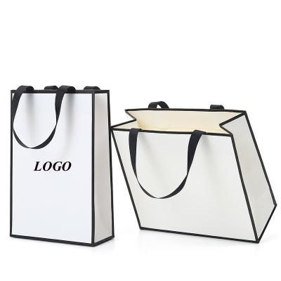 China Recyclable Customize Logo Printed White Boutique Shopping Clothes Paper Bag With Ribbon Handle for sale