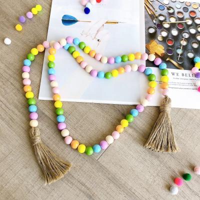 China Hot Sale Europe Amazon Amazon Rustic Colorful Jute Tassels Wooden Bead Garland Hanging Home Decor Farmhouse Decor for sale