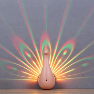 China Love Gift Rechargeable LED Changed Remote Control Wall Peacock Projector Night Light For Bedroom Kids Room for sale