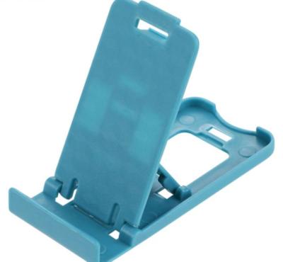 China Adjustable Adjustable Portable Fold-out Mobile Phone Holder Cradle Desk Stand for iPad Tablet E-Reader for sale