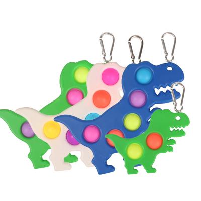 China Chridren Plays Dinosaur Wholesale Cheap Dimple Popet Simple Keychain With Different Sizes And Colors For Kids And Adults for sale