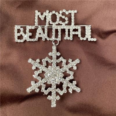 China Crystal Word Snowflake Design Brooch Sash Crystal Rhinestone Pins Wholesale Custom Letter Pin for sale