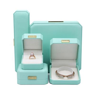 China Jewelry Packaging Custom Set Leather Material Light Blue Jewelry Packaging Boxes With Metal Plate for sale