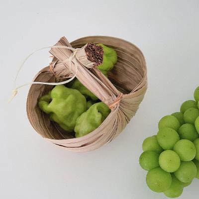 China Sustainable Palm Leaf Woven Fruit Basket Ginger Garlic Storage Baskets Handmade Household Kitchen Onion Products 15*10cm for sale