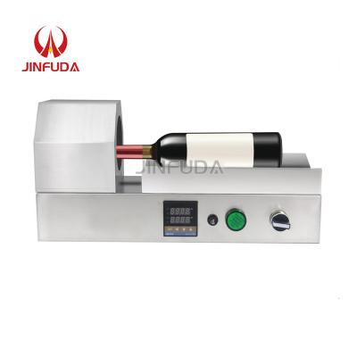 China Manual food PVC film capsule heat shrinker oil wine capsule heat seal film capsule sleeve shrink wrapping machine for sale