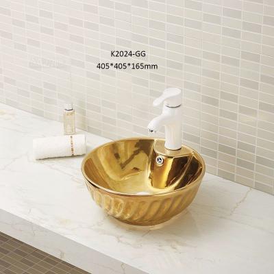 China Large Gold Color Bathroom Sink Modern Elegant Ceramic Countertop Unique Design Wash Basin In Bathroom for sale