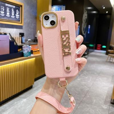 China Shockproof Personalize Name Strap PU Lychee Leather Phone Case For iPhone 14 Pro Max Plus Lanyard Diamond Metal Letter Cover for sale