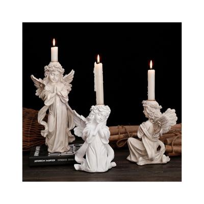 China Home Decoration Resin Christ Ornament Catholic Cupid Candle Holder Praying Angel Candlestick For Religious Activities for sale