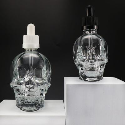 China High Quality Unique Liquid Bottle 30ml 60ml Clear Skull Shape Glass Dropper Bottle for sale