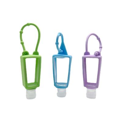 China Trapezium Pet Hand Soap Keychain Hand Sanitizer Bottle 30ml Plastic Portable Hand Sanitizer Bottle With Silicone Holder for sale