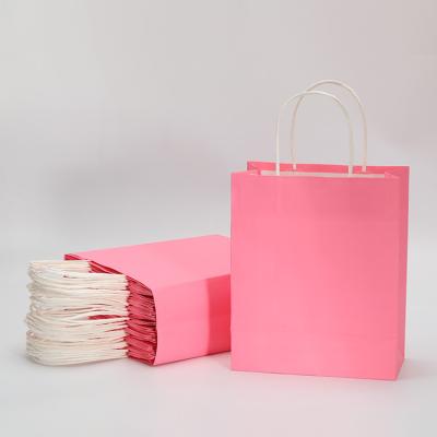 China Recyclable Manufacturers Wholesale Custom Logo Printing Pink Kraft Paper Gift Packaging Bag With Handle for sale