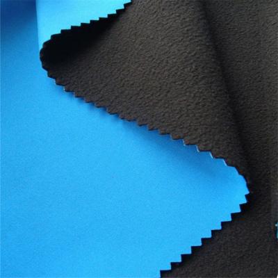 China Stretch Hot Sale 320gsm Embossed Breathable 3 Layer Softshell Spandex Fabric for sale