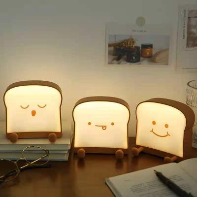 China Interesting Bracket Children's Mobile Phone Foot Lamp Silicon Modern Creative Decoration Bread Lamp Desk Toast Night's Gift Lamp for sale