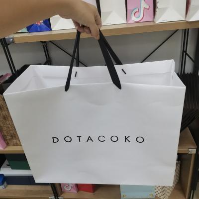 China Recyclable Wholesale Customized Luxury Logo Brand White Paper Gift Package Luxury Shopping Bag With Handle for sale