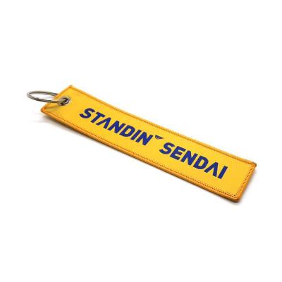 China Custom Cheap Promotional Jet Tag Fabric Embroidery Car Keychains Woven Key Chain for Party Favors for sale