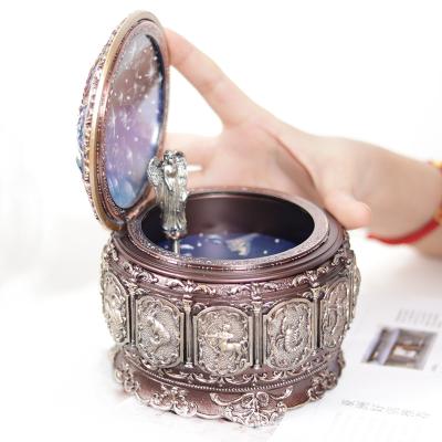 China Eco-friendly Round Vintage Constellations Rotating LED Lights Glitter Resin Carved Mechanism Musical Box Zodiac Gift Music Box For Birthday for sale