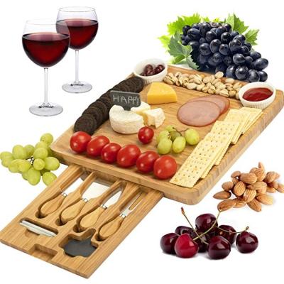 China Sustainable Bamboo Cheese Board with 4 Pieces Stainless Steel Cutlery Set Charcuterie Board Bamboo Cheese Tray with Drawer for sale