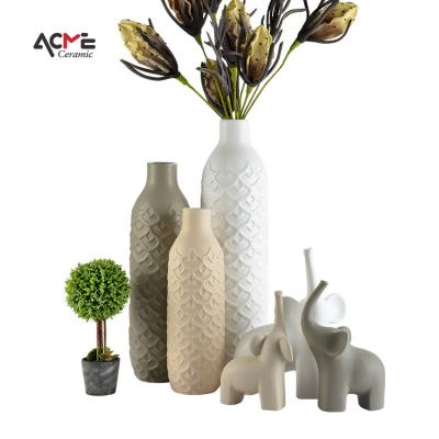 China Minimalist indoor home living room ornaments bottle Nordic style relief flower vase ceramic crafts for home decor for sale