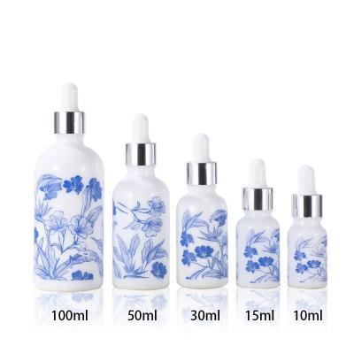 China Personal Care Unique Design Blue Classic Transparent Luxury Cosmetic Glass Bottle for sale