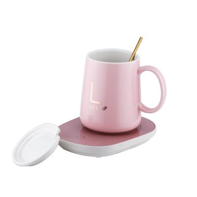 China Sustainable Luxury Pink Cooler Ceramic Coffee Mug Warmer Mug With Heater And Straw for sale